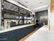 Modern kitchen boasts navy cabinets, marble countertops, and large window overlooking outdoor space at 3337 E Alexander Dr, San Tan Valley, AZ 85143