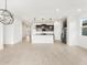 Open-concept living space featuring a kitchen island, stainless steel refrigerator, and tile flooring at 3337 E Alexander Dr, San Tan Valley, AZ 85143