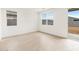 Bright, empty room with wood-style tile flooring and sliding glass door at 3337 E Alexander Dr, San Tan Valley, AZ 85143