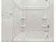 Clean white shower-tub combo with built-in shelves and chrome fixtures at 3337 E Alexander Dr, San Tan Valley, AZ 85143
