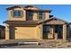 Two-story home featuring stone accents, a two-car garage, and a covered entryway at 10918 E Texas Ave, Mesa, AZ 85212