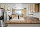 Eat-in kitchen featuring cream colored cabinets, stainless steel appliances, and a large window for natural light at 5810 N 8Th Pl, Phoenix, AZ 85014