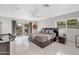 Bright bedroom with tile floors, modern furnishings, and a sliding door to the outdoor patio at 9175 N 82 St, Scottsdale, AZ 85258
