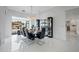 Elegant dining room featuring modern lighting, sleek furniture, and an open view to the outside at 9175 N 82 St, Scottsdale, AZ 85258