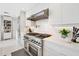 Modern kitchen equipped with a stainless steel range, stylish fixtures, and sleek white countertops at 9175 N 82 St, Scottsdale, AZ 85258