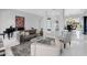 Bright living room with piano, modern art, stylish furniture, and a view to the dining area at 9175 N 82 St, Scottsdale, AZ 85258