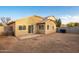 Backyard view of the house with a small patio at 1952 N 103Rd Dr, Avondale, AZ 85392