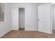 Well-lit bedroom featuring a mirrored closet and neutral carpeting at 1952 N 103Rd Dr, Avondale, AZ 85392