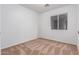 Well-lit bedroom featuring neutral walls and carpet at 1952 N 103Rd Dr, Avondale, AZ 85392
