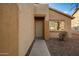 Tan house with a two-car garage and neutral landscaping at 1952 N 103Rd Dr, Avondale, AZ 85392