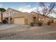 Tan house with a two-car garage and neutral landscaping at 1952 N 103Rd Dr, Avondale, AZ 85392