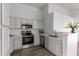 Modern kitchen with light gray cabinets, stainless steel appliances, and quartz countertops at 1952 N 103Rd Dr, Avondale, AZ 85392
