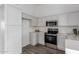 Modern kitchen with light gray cabinets and stainless steel appliances at 1952 N 103Rd Dr, Avondale, AZ 85392