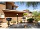 Community grilling area with two grills and a stone bench at 20100 N 78Th Pl # 2143, Scottsdale, AZ 85255