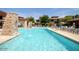 Inviting resort-style pool with stone accents and comfortable seating at 20100 N 78Th Pl # 2143, Scottsdale, AZ 85255