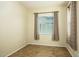 Neutral bedroom with wood-look flooring, natural light, neutral walls, and window with matching curtains at 42086 W Solitare Dr, Maricopa, AZ 85138