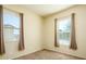 Bedroom with neutral carpet, neutral walls, two windows, and matching curtains at 42086 W Solitare Dr, Maricopa, AZ 85138