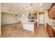 Open concept kitchen with granite countertops, pendant lighting, and stainless steel appliances at 42086 W Solitare Dr, Maricopa, AZ 85138
