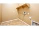 Laundry room features wood-look tile floors and convenient utility connections and shelf at 42086 W Solitare Dr, Maricopa, AZ 85138