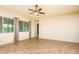 Spacious living room has tile floors, a ceiling fan, and a large window with natural light at 42086 W Solitare Dr, Maricopa, AZ 85138