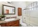 Cozy bathroom boasting a glass-enclosed shower, granite counters, and wood cabinetry at 10851 E Le Marche Dr, Scottsdale, AZ 85255