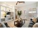 Bright living room features built-in shelving and a decorative ceiling fan for added comfort at 10851 E Le Marche Dr, Scottsdale, AZ 85255