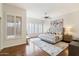Sun-drenched main bedroom features stylish shutters, elegant decor, and a ceiling fan at 10851 E Le Marche Dr, Scottsdale, AZ 85255