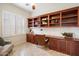 Functional office features custom wooden built-ins, providing ample storage and workspace at 10851 E Le Marche Dr, Scottsdale, AZ 85255