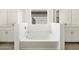 Bathroom with a tub in between two vanities with mirrors and gray tiled flooring at 3649 E Alexander Dr, San Tan Valley, AZ 85143
