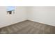 Bedroom with neutral carpet, window, and white trim at 3649 E Alexander Dr, San Tan Valley, AZ 85143