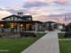 A community amenity including a clubhouse, picnic tables and seating under a beautiful sunset sky at 3649 E Alexander Dr, San Tan Valley, AZ 85143