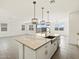 Open-concept kitchen island with pendant lighting and stainless steel sink at 3649 E Alexander Dr, San Tan Valley, AZ 85143