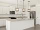 Modern kitchen features white cabinets, granite countertops, and a large center island at 3649 E Alexander Dr, San Tan Valley, AZ 85143