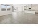 Bright and open living area leading to a modern kitchen, featuring sleek tile floors and ample natural light at 3649 E Alexander Dr, San Tan Valley, AZ 85143