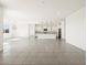 Spacious open-concept living area with ceramic tile flooring and a view to the kitchen at 3649 E Alexander Dr, San Tan Valley, AZ 85143