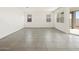 Bright living room featuring tile floors and large windows with backyard access, creating an inviting space at 3649 E Alexander Dr, San Tan Valley, AZ 85143