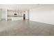 Spacious open-concept living area with ceramic tile flooring and a view to the kitchen at 3649 E Alexander Dr, San Tan Valley, AZ 85143