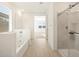 Bright bathroom boasts a soaking tub, walk-in shower, and modern vanity at 36833 W La Paz St, Maricopa, AZ 85138