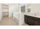 Bathroom features a soaking tub, shower and dark brown vanity at 36833 W La Paz St, Maricopa, AZ 85138