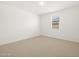 Well-lit bedroom featuring neutral wall and carpet at 36833 W La Paz St, Maricopa, AZ 85138