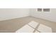 Spacious bedroom with neutral carpet and window at 36833 W La Paz St, Maricopa, AZ 85138