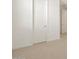 Spacious bedroom with neutral carpeting and a door at 36833 W La Paz St, Maricopa, AZ 85138