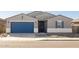 Single-story home with a two-car garage and landscaped yard at 36833 W La Paz St, Maricopa, AZ 85138