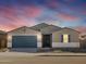 Single-story home with two-car garage and desert landscaping at 36833 W La Paz St, Maricopa, AZ 85138