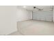 Attached garage with overhead door and concrete floor at 36833 W La Paz St, Maricopa, AZ 85138