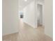 Light and bright hallway with wood-look tile flooring at 36833 W La Paz St, Maricopa, AZ 85138