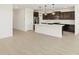 Modern kitchen with dark cabinetry and an island at 36833 W La Paz St, Maricopa, AZ 85138
