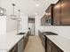 Open concept kitchen with island, stainless steel appliances, and light wood floors at 36833 W La Paz St, Maricopa, AZ 85138