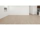 Open concept living room features wood-look floors and kitchen access at 36833 W La Paz St, Maricopa, AZ 85138