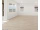 Bright living room with hardwood floors and large windows at 36833 W La Paz St, Maricopa, AZ 85138